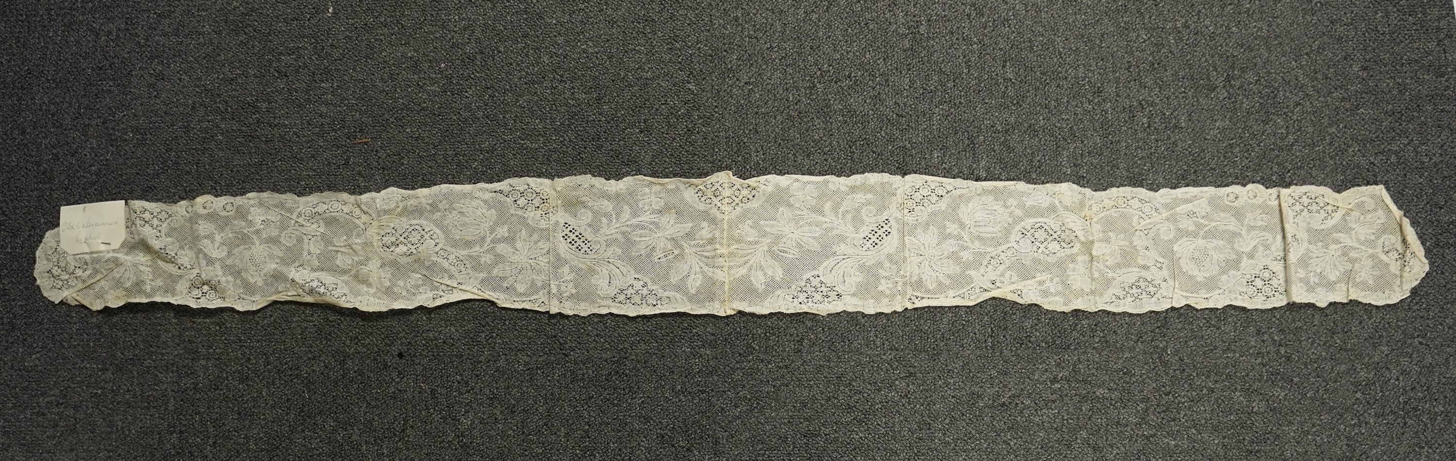 A collection of 18th century needle and bobbin lace. Including an 18th century wide pair of joined Valenciennes lace lappets, a similar 18th century cap back, an ornately worked Point de Alencon cap crown and another sim
